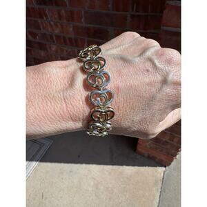 Elegant silver and gold tone interlocking heart bracelet